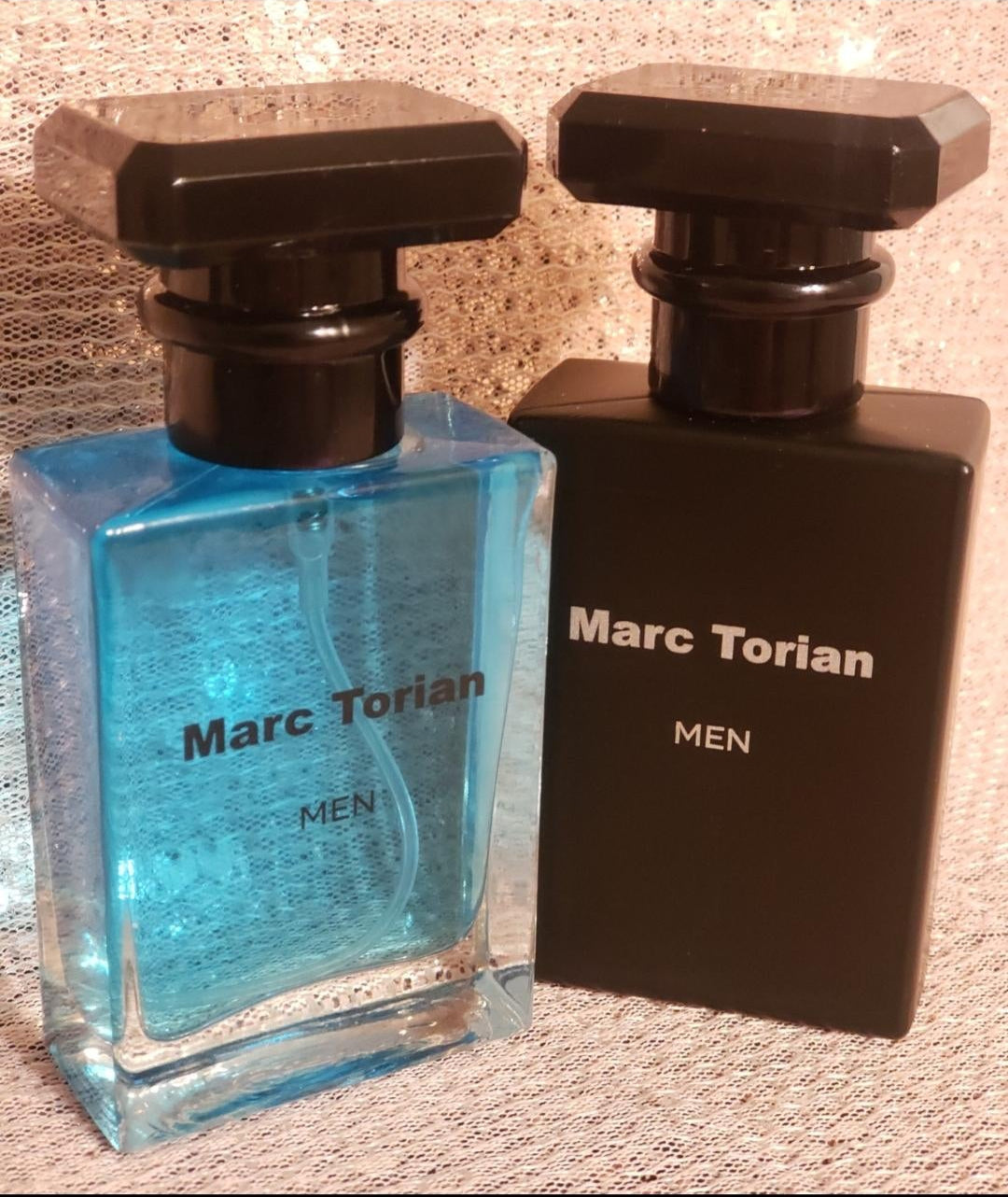 Two bottles of Marc Torian men's cologne, blue & black.